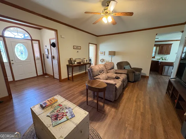 a living room with furniture and a wooden floor