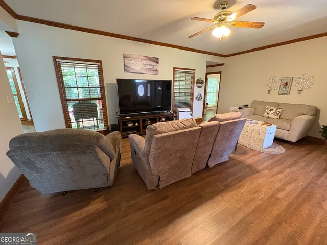 a living room with furniture and a flat screen tv