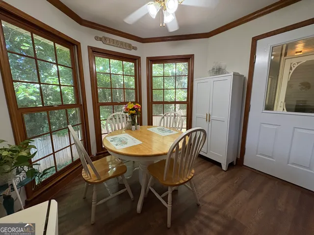 a view of a dining room with furniture window and wooden floor