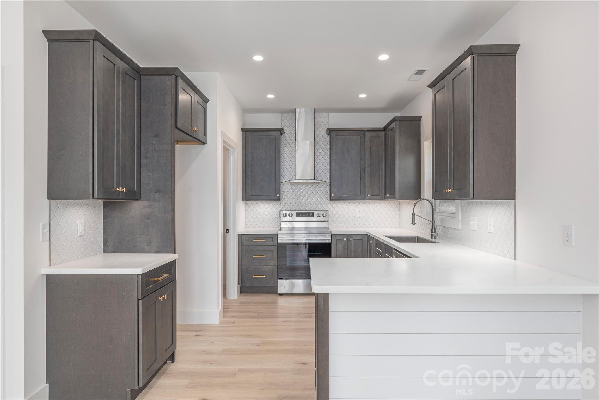 32 Oak Hill Road Candler, NC 28715 - Photo 10 of 29 a large kitchen with stainless steel appliances a sink dishwasher stove refrigerator and cabinets