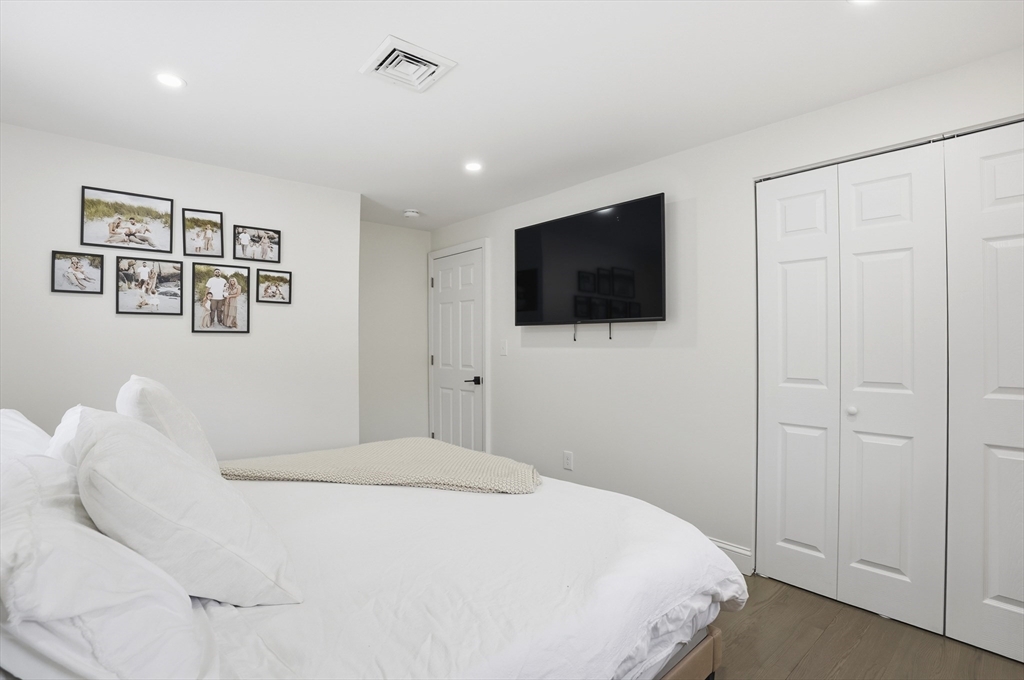 82 Water Street Saugus, MA 01906 - Photo 14 of 40 a bedroom with a bed and a flat screen tv