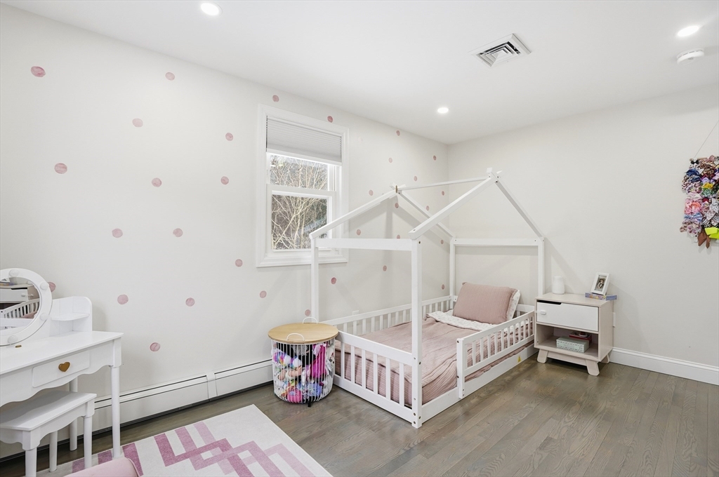 82 Water Street Saugus, MA 01906 - Photo 17 of 40 a spacious bedroom with a bed and a table