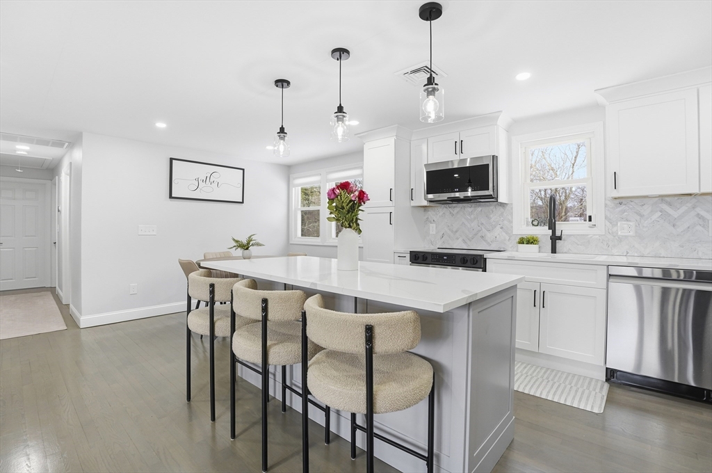 82 Water Street Saugus, MA 01906 - Photo 2 of 40 a kitchen with stainless steel appliances kitchen island a white cabinets and chairs