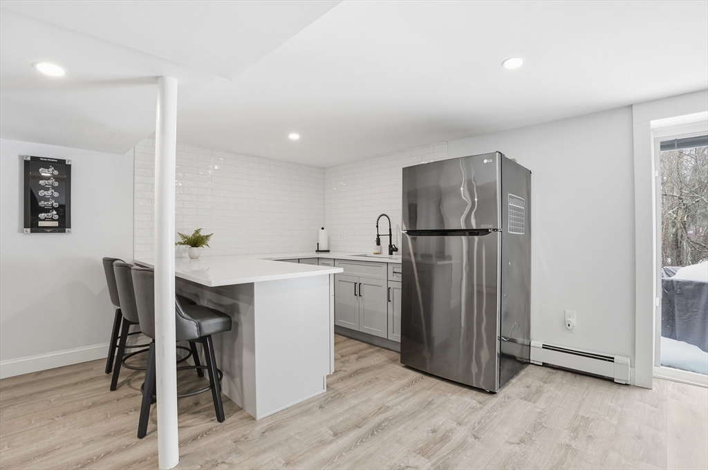 82 Water Street Saugus, MA 01906 - Photo 28 of 40 a kitchen with a refrigerator a table and chairs