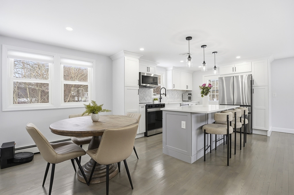 82 Water Street Saugus, MA 01906 - Photo 3 of 40 a kitchen with a dining table chairs and refrigerator