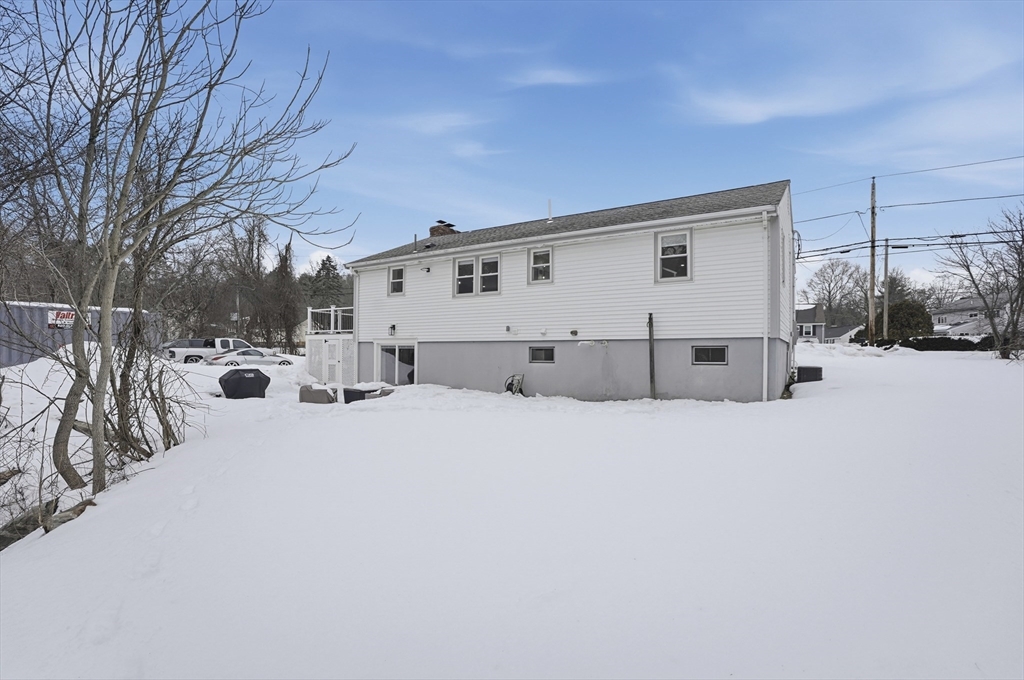 82 Water Street Saugus, MA 01906 - Photo 39 of 40 a view of parking space with snow on the road