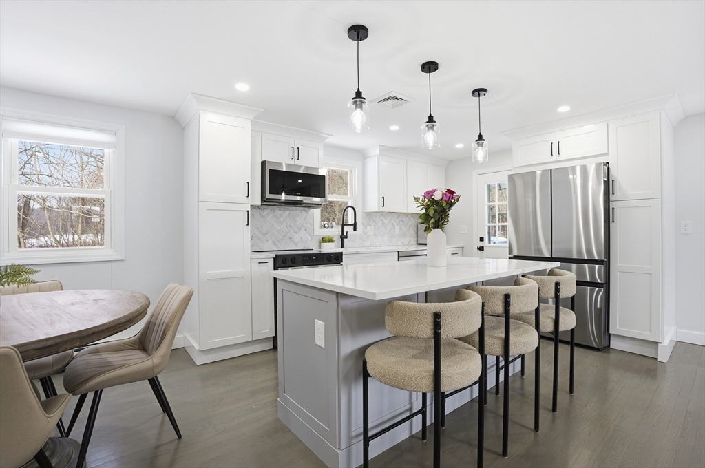 82 Water Street Saugus, MA 01906 - Photo 4 of 40 a kitchen with kitchen island appliances cabinets and chair