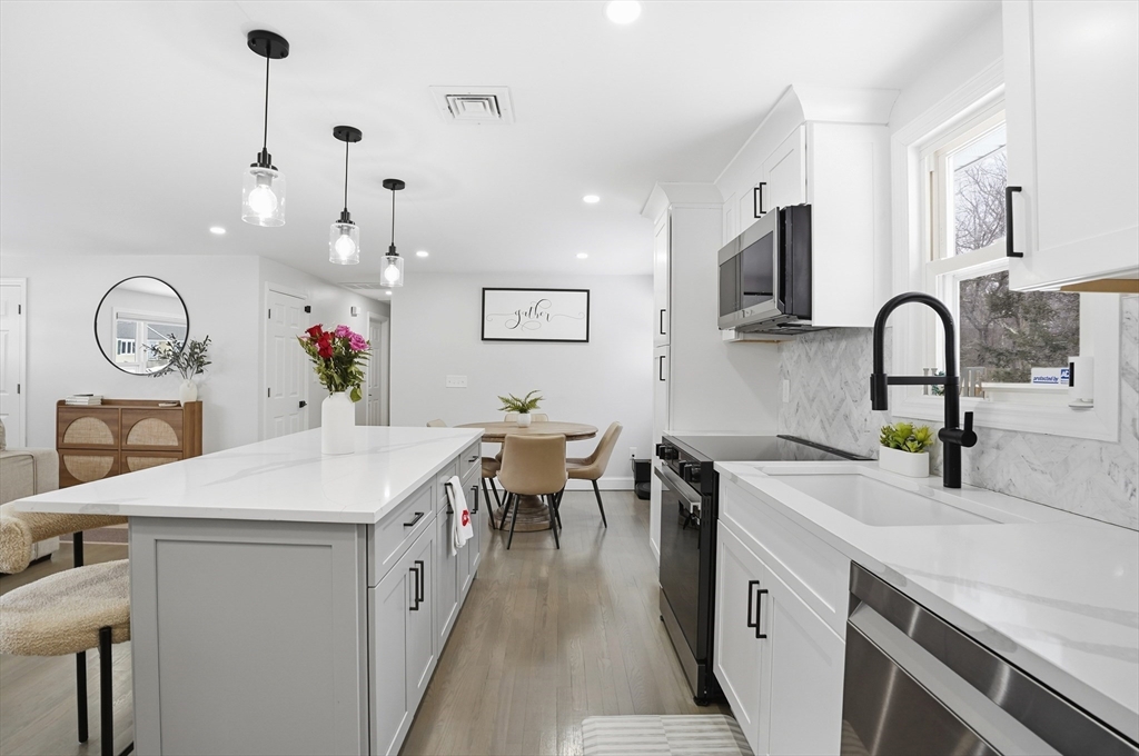 82 Water Street Saugus, MA 01906 - Photo 5 of 40 a kitchen with a sink cabinets and wooden floor