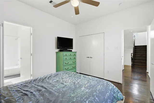 a bedroom with a bed and a television