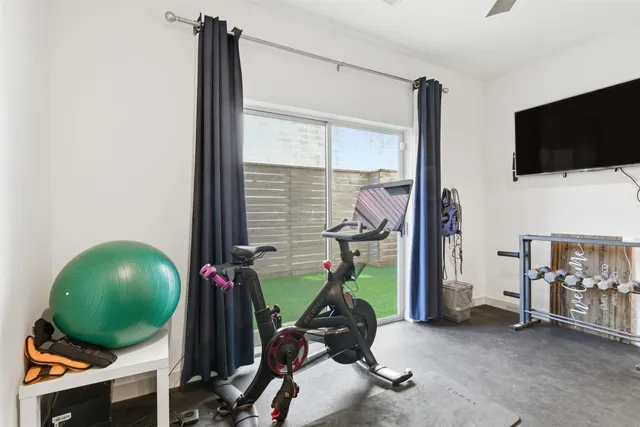 a view of a workspace with furniture and a flat screen tv