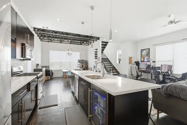 a kitchen with sink a stove and cabinets