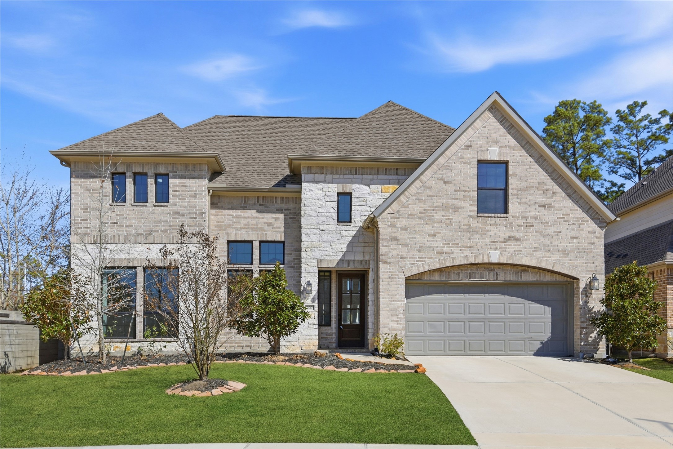 17501 Spice Merlot Lane Conroe, TX 77302 - Photo 2 of 50 a front view of a house with a yard