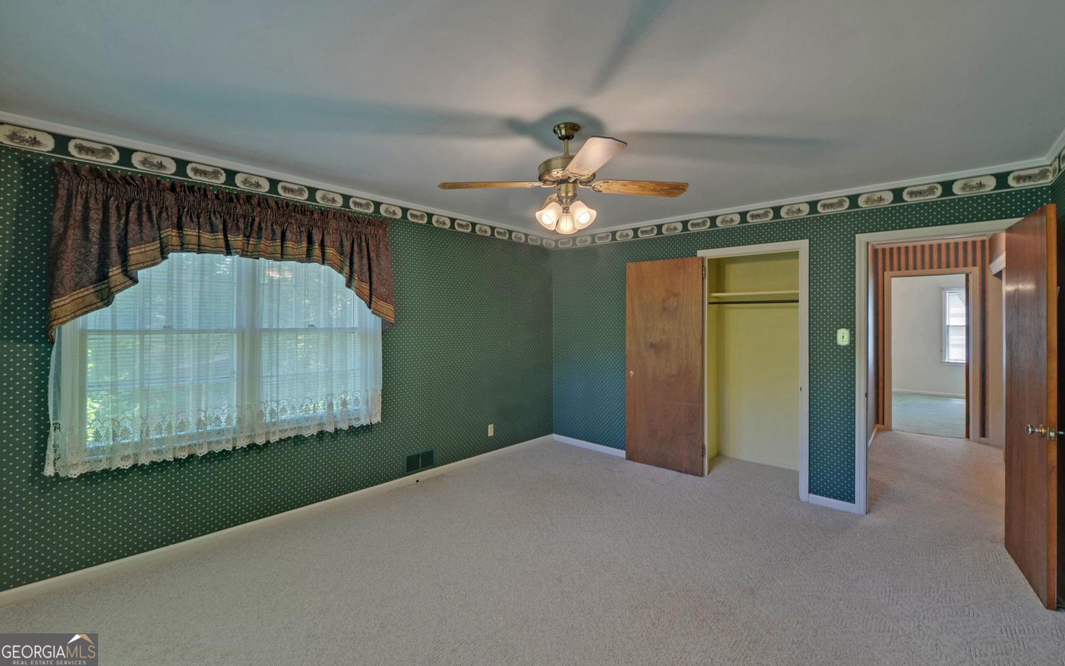 400 Harris Street Toccoa, GA 30577 - Photo 18 of 49 en empty room with wooden floor and fan