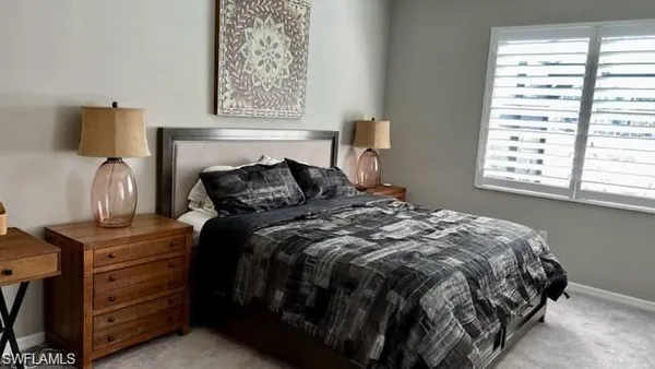 a bed room with a bed window and a television