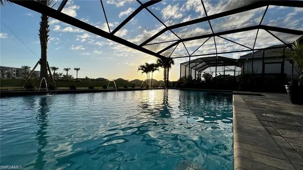 a view of a backyard with a lake view and sitting area