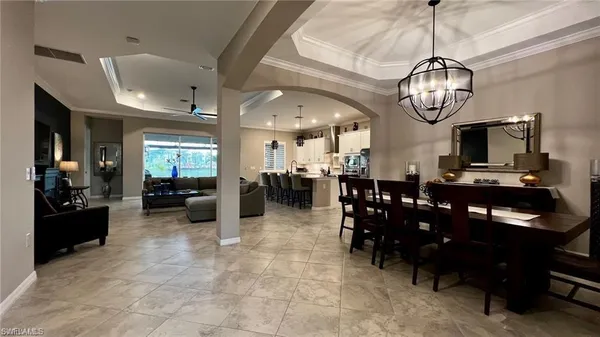 a living room with lots of furniture and kitchen view