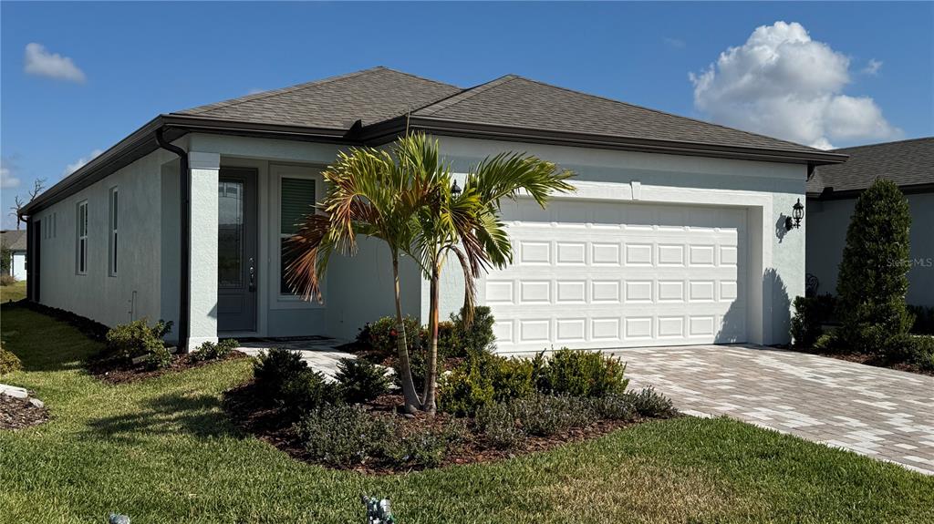 9408 Coastline Way Palmetto, FL 34221 - Photo 1 of 41 a front view of a house with garden