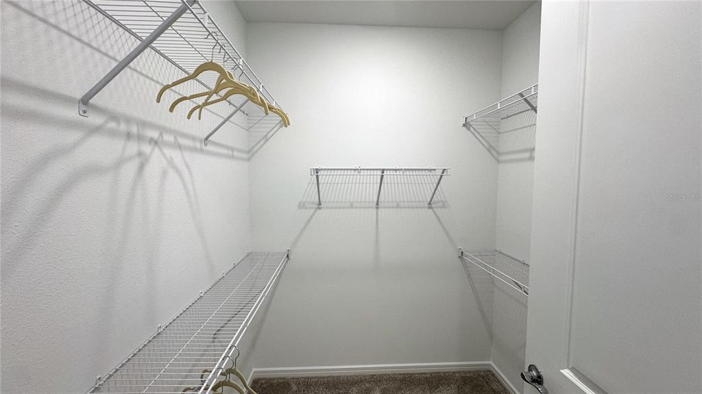 9408 Coastline Way Palmetto, FL 34221 - Photo 13 of 41 a view of a room with racks on the wall