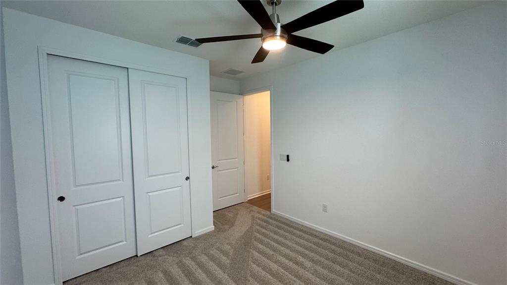 9408 Coastline Way Palmetto, FL 34221 - Photo 17 of 41 a view of empty room with wooden floor