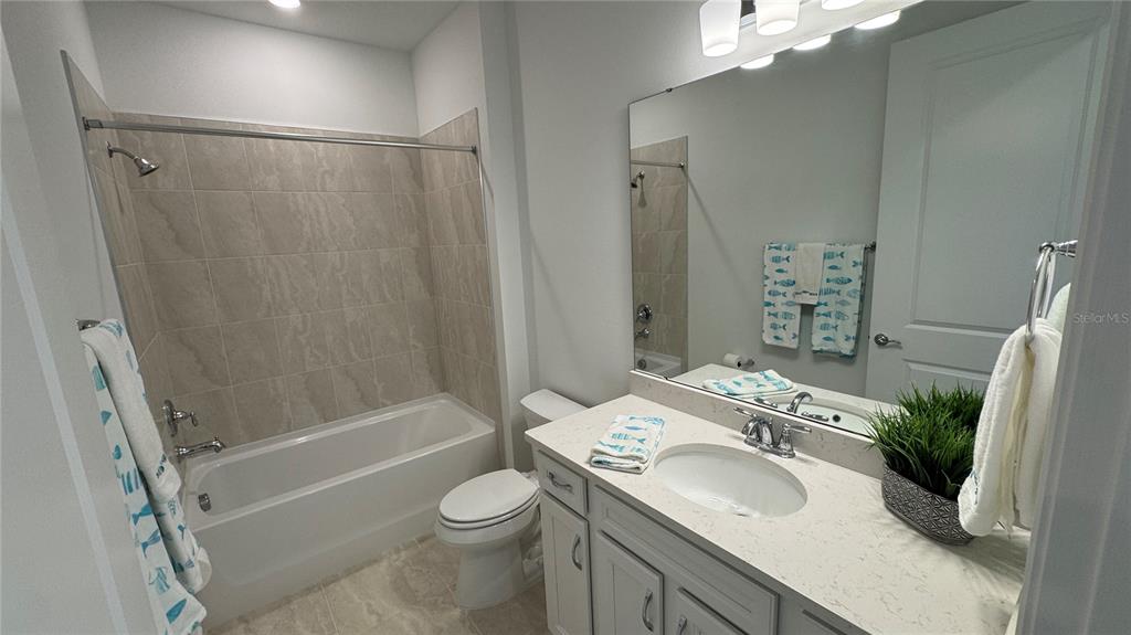 9408 Coastline Way Palmetto, FL 34221 - Photo 18 of 41 a bathroom with a sink toilet and shower