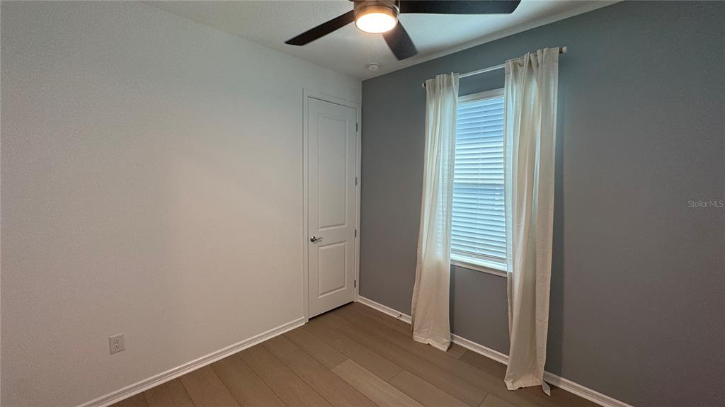9408 Coastline Way Palmetto, FL 34221 - Photo 20 of 41 an empty room with wooden floor closet and windows