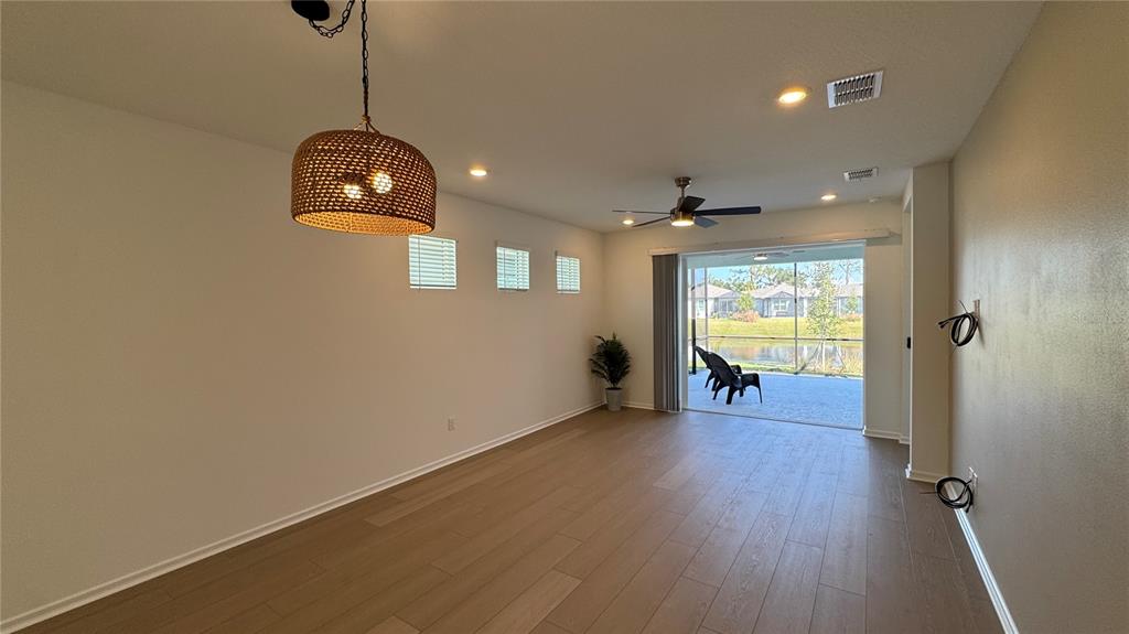 9408 Coastline Way Palmetto, FL 34221 - Photo 3 of 41 a view of empty room with wooden floor and window
