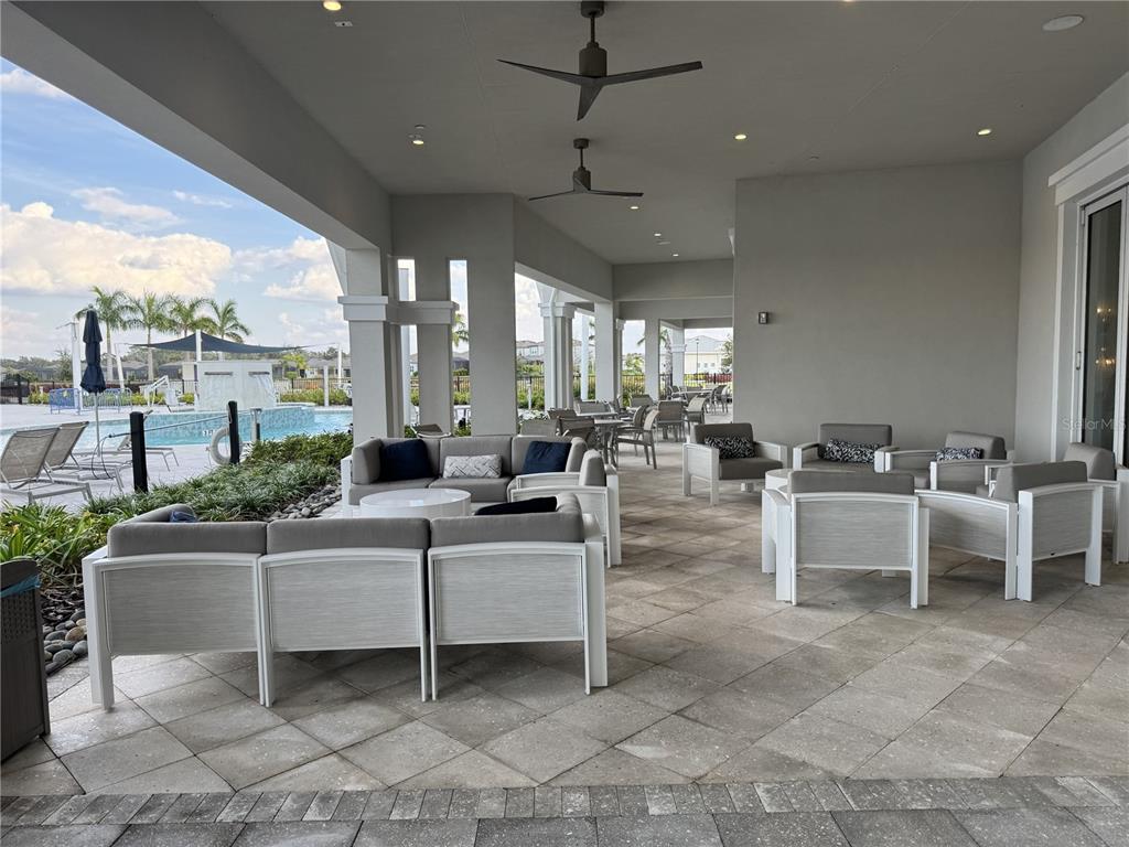 9408 Coastline Way Palmetto, FL 34221 - Photo 31 of 41 a living room with couches a coffee table and chairs