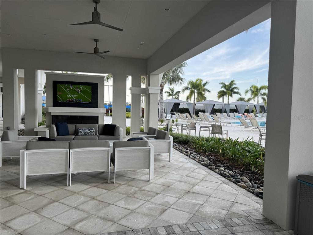 9408 Coastline Way Palmetto, FL 34221 - Photo 32 of 41 a living room with furniture a fireplace and a flat screen tv