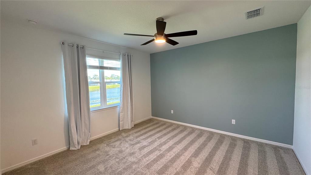 9408 Coastline Way Palmetto, FL 34221 - Photo 8 of 41 an empty room with closet and windows