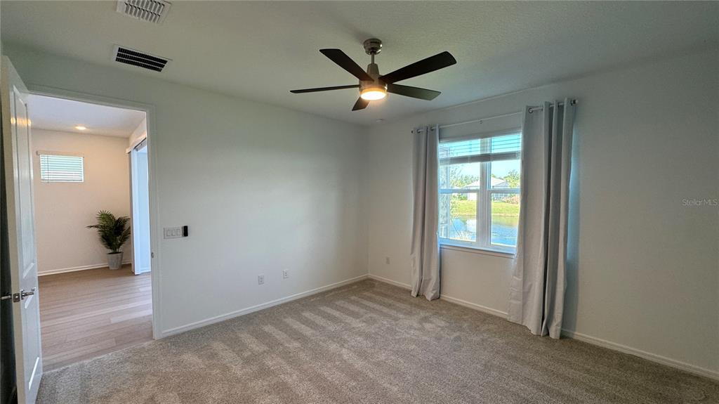 9408 Coastline Way Palmetto, FL 34221 - Photo 9 of 41 an empty room and closet area with wooden floor