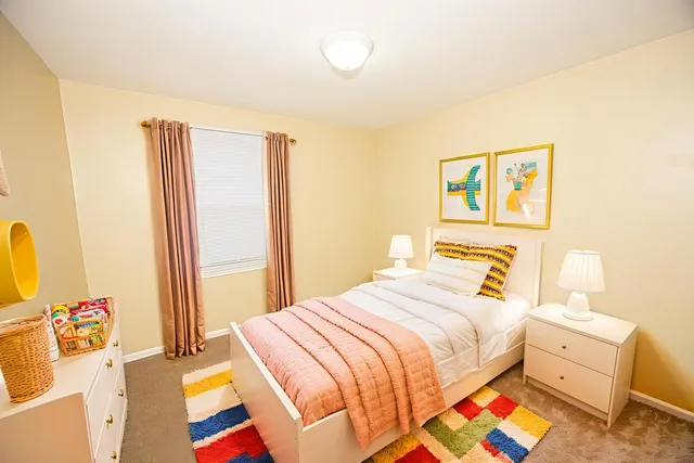 a bedroom with a bed and a dresser