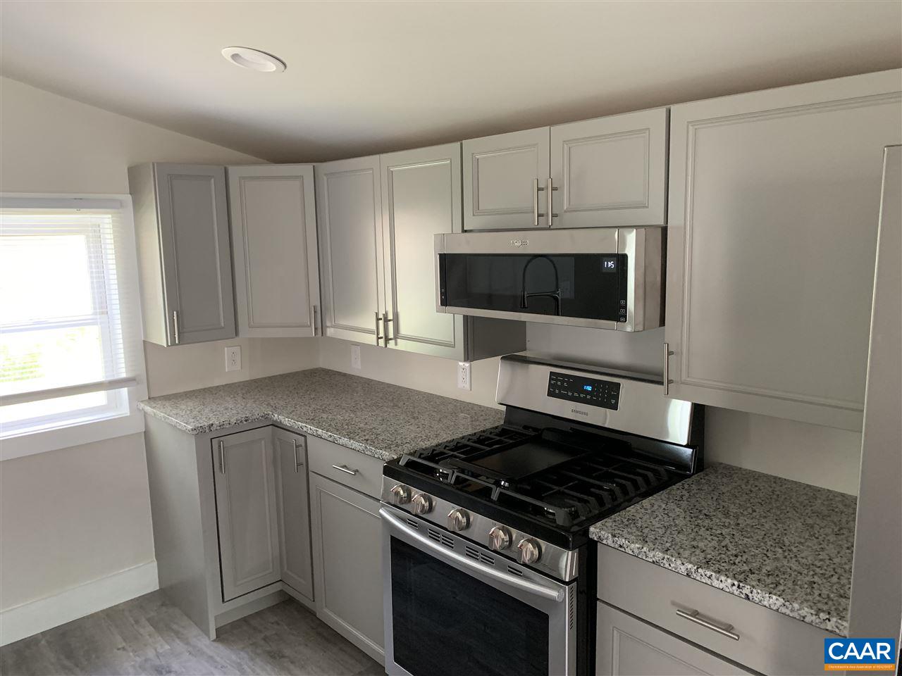 1109 Myrtle Street, Unit B Charlottesville, VA 22902 - Photo 4 of 14 a kitchen with granite countertop a stove and a sink