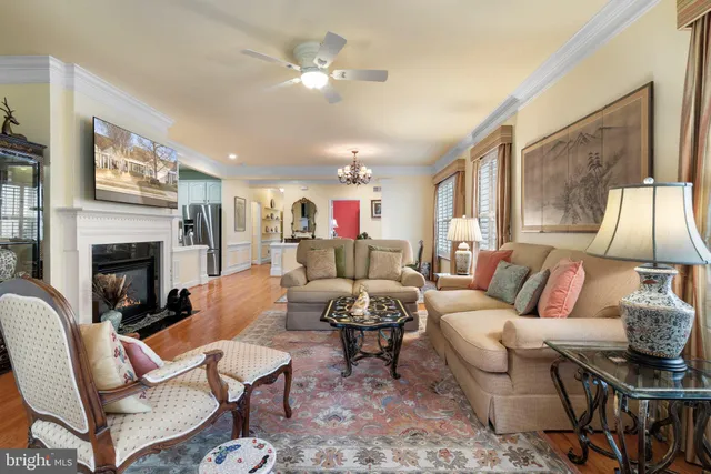 a living room with furniture fireplace and a large window