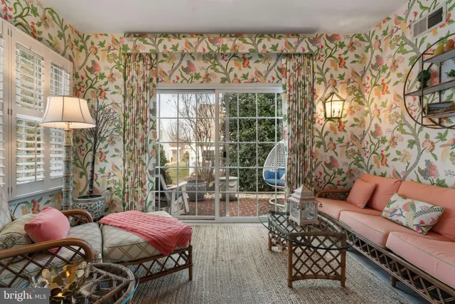 a living room with furniture and a floor to ceiling window