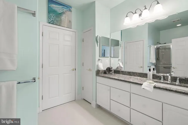 a bathroom with a double vanity sink mirror and