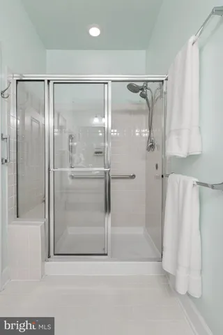 a bathroom with a glass shower door