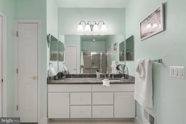 a bathroom with a double vanity sink and a mirror
