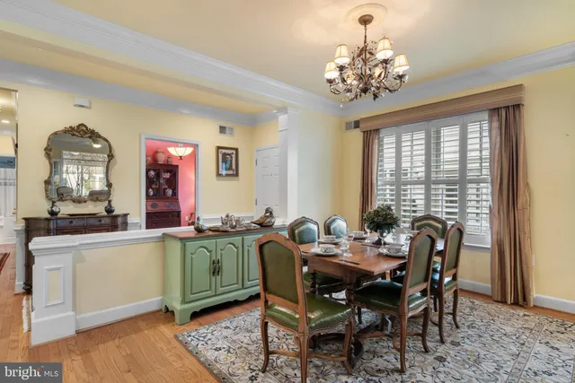 a view of a dining room with furniture and chandelier