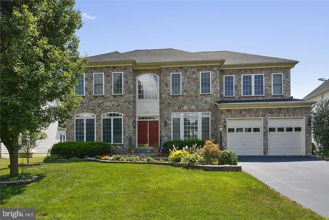 a front view of a house with a yard and outdoor seating