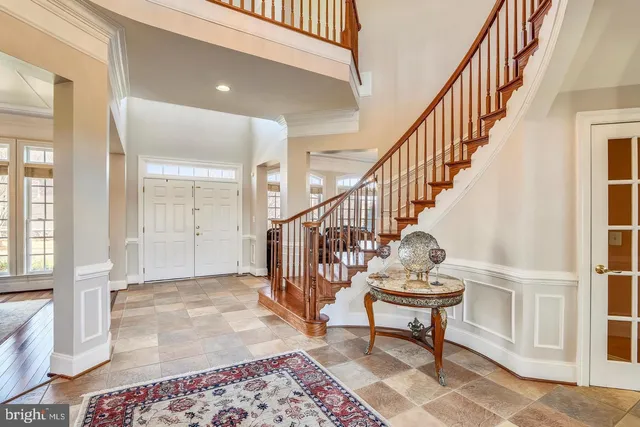 a living room with furniture a rug and a floor to ceiling window