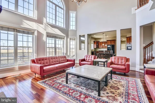 a living room with furniture ceiling fan and a chandelier