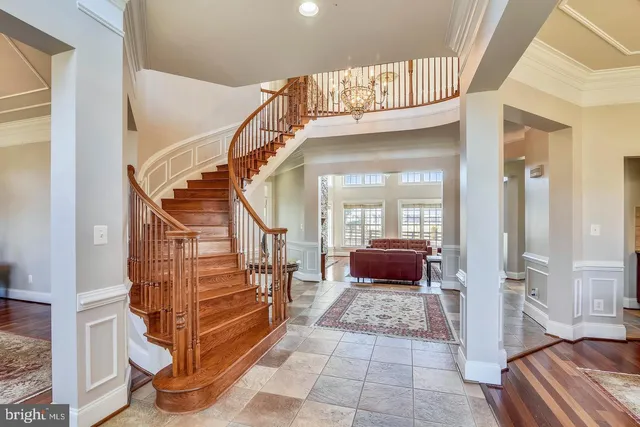 a spacious bedroom with a bed and wooden floor