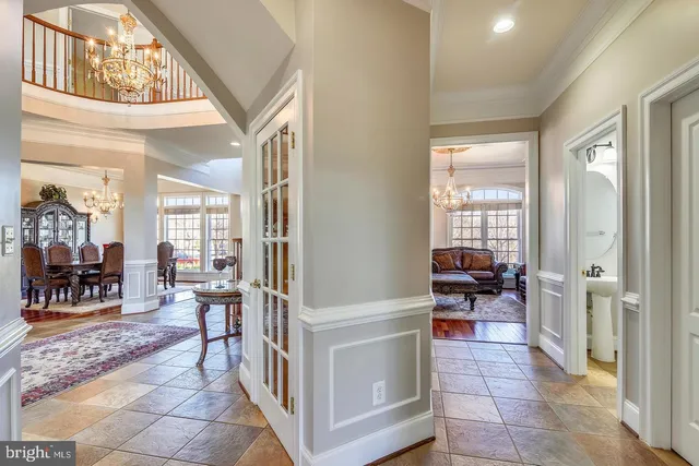 a living room with furniture a rug and a chandelier
