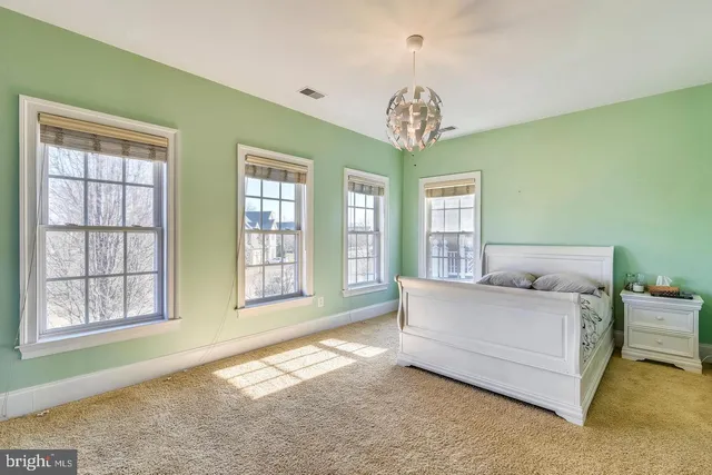 a front view of a house with a garden and pathway