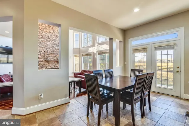 a view of a dining room with furniture and chandelier