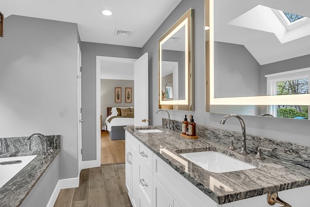 35 Wadsworth Road Ashland, MA 01721 - Photo 18 of 32 a bathroom with a granite countertop sink and a mirror
