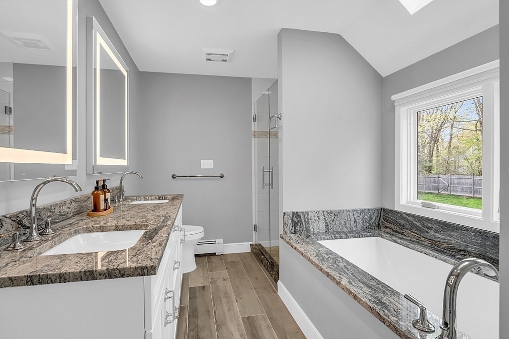 35 Wadsworth Road Ashland, MA 01721 - Photo 19 of 32 a bathroom with a granite countertop tub sink and mirror