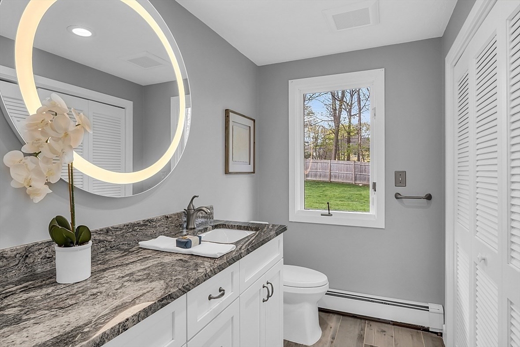 35 Wadsworth Road Ashland, MA 01721 - Photo 23 of 32 a bathroom with a granite countertop sink a toilet and a mirror