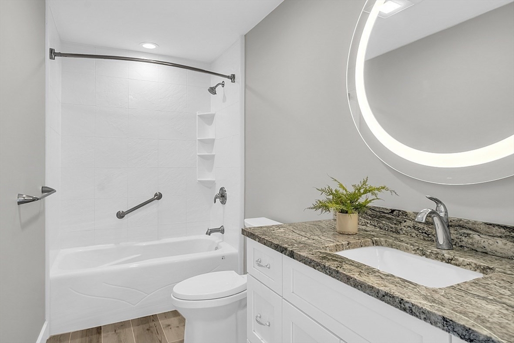35 Wadsworth Road Ashland, MA 01721 - Photo 27 of 32 a bathroom with a granite countertop sink toilet and a bathtub