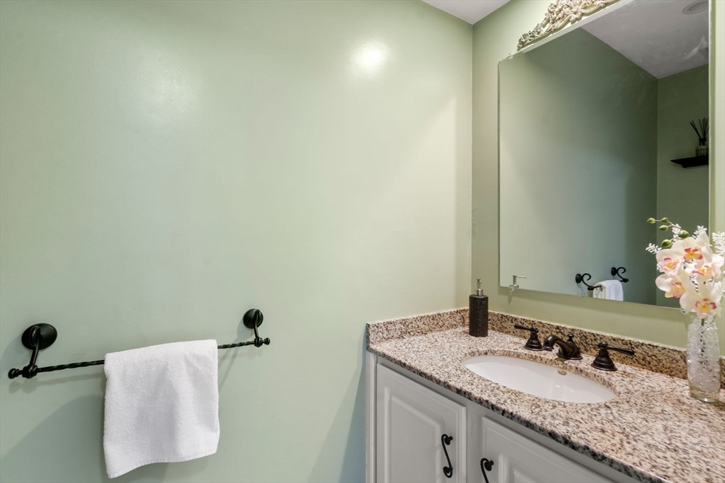 21 Hartwell Place, Unit 21 Canton, MA 02021 - Photo 15 of 33 a bathroom with a granite countertop sink and a mirror